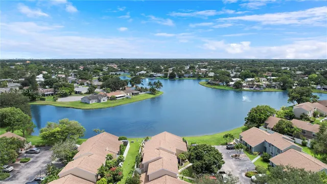 an aerial view of a house with a lake view