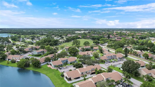 an aerial view of residential houses with outdoor space and river