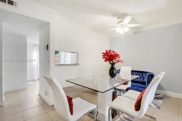 a dining room with furniture and window