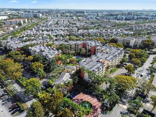 an aerial view of a house with a yard and large trees