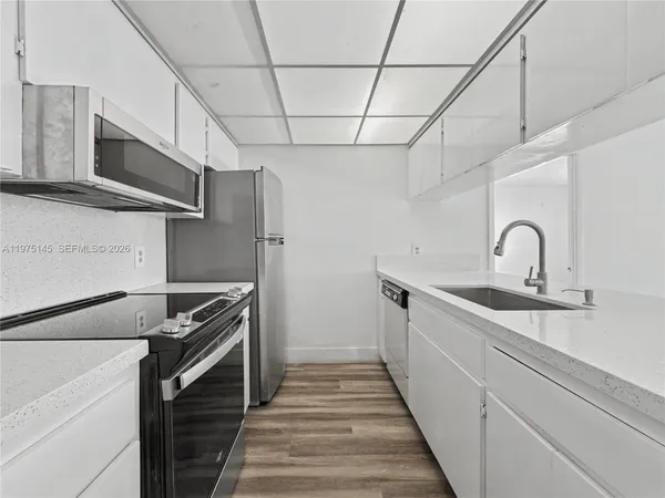 a kitchen with stainless steel appliances a sink and a stove