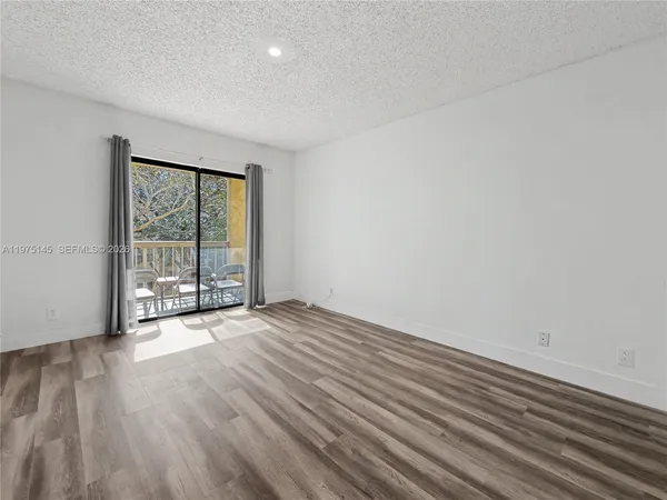 a spacious bedroom with a bed and a large window