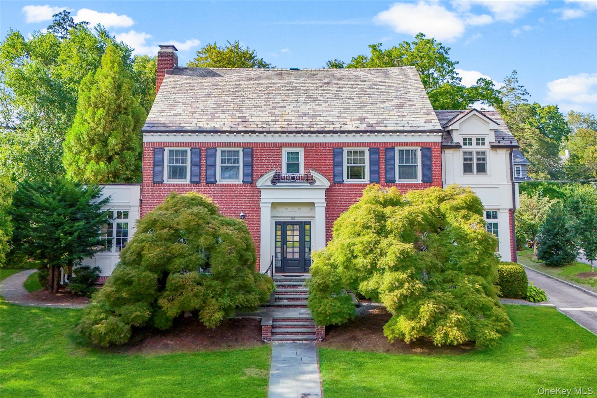 80 Forest Avenue New Rochelle, NY 10804 - Photo 2 of 48 a front view of a house with garden