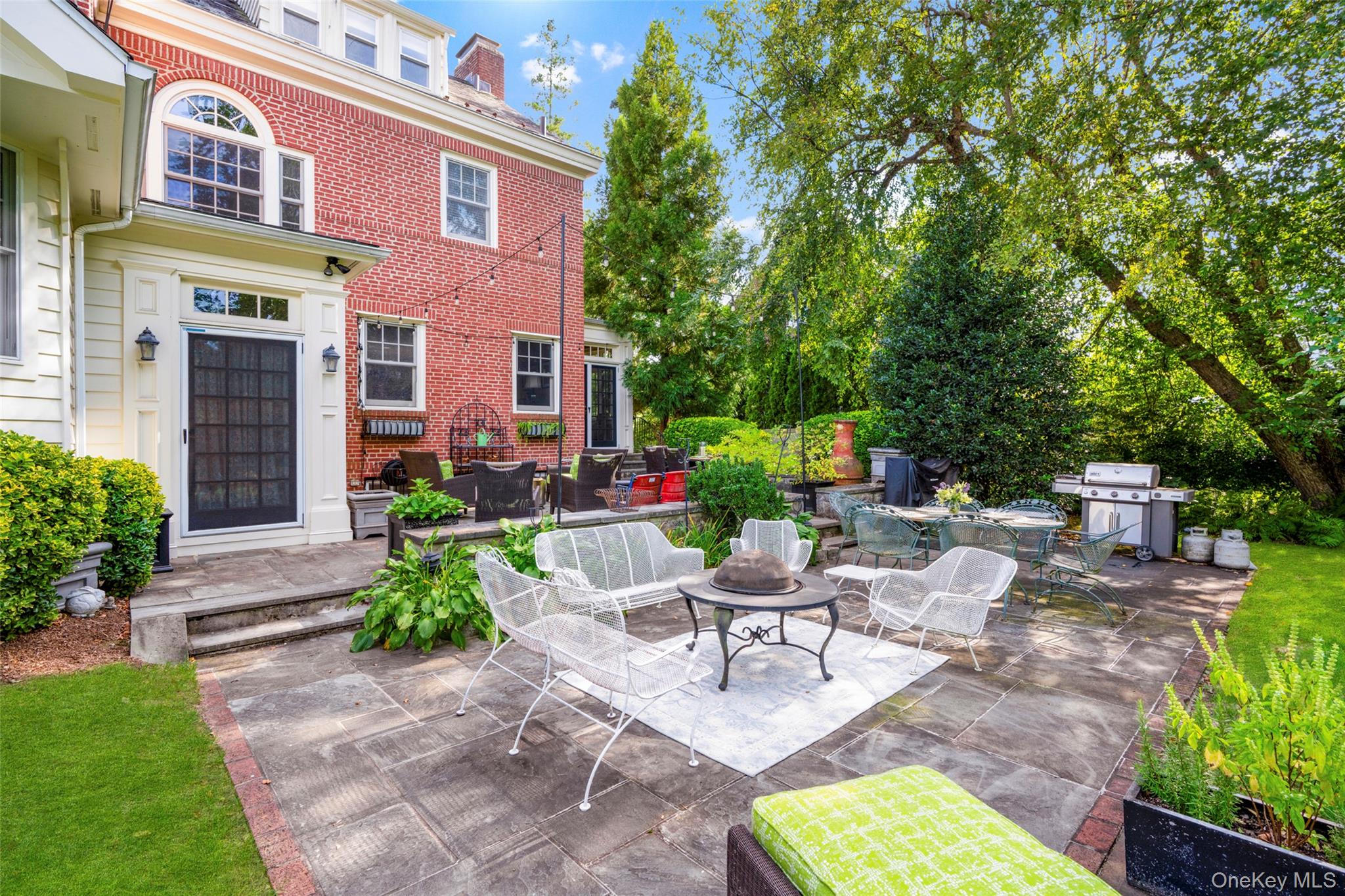 80 Forest Avenue New Rochelle, NY 10804 - Photo 38 of 48 a view of a patio with couches table and chairs potted plants and large tree