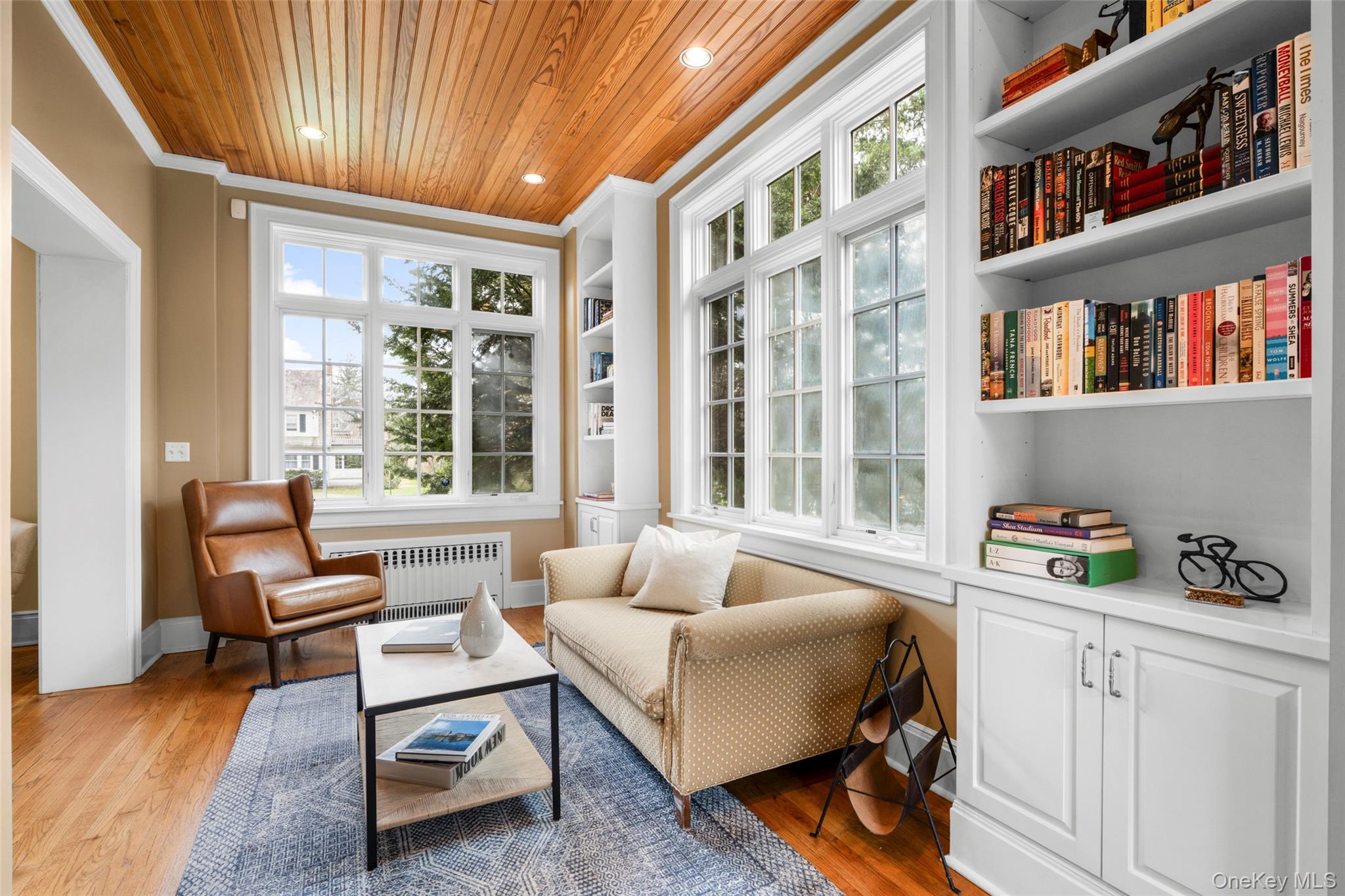 80 Forest Avenue New Rochelle, NY 10804 - Photo 10 of 48 a living room with furniture and a book shelf