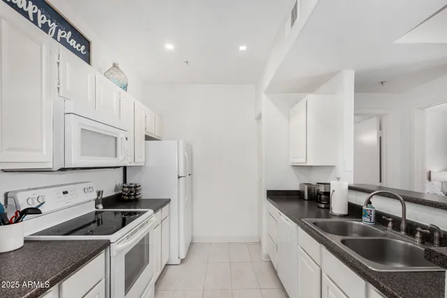a kitchen that has a sink and a stove