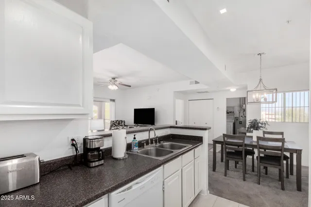 a kitchen with a sink cabinets and window