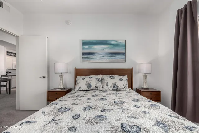 a bedroom with a bed and a painting