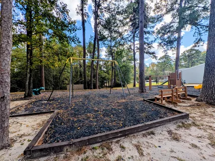 a view of a house with backyard and a patio