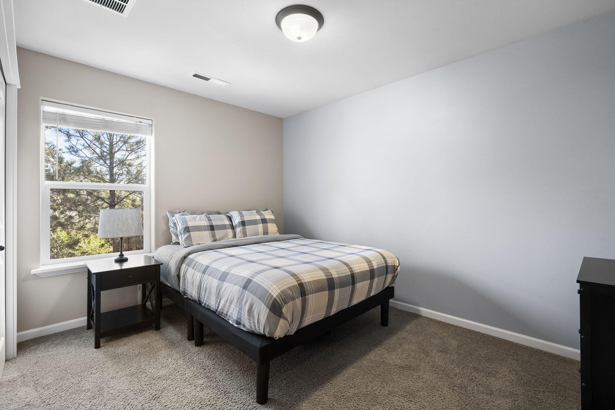 62906 Bilyeu Way Bend, OR 97701 - Photo 24 of 100 a bed sitting in a bedroom next to a window