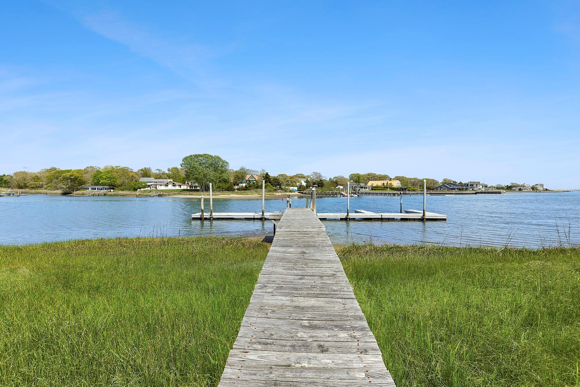 47 Rampasture Road, Unit M Hampton Bays, NY 11946 - Photo 13 of 17 a view of a lake with houses in outdoor space