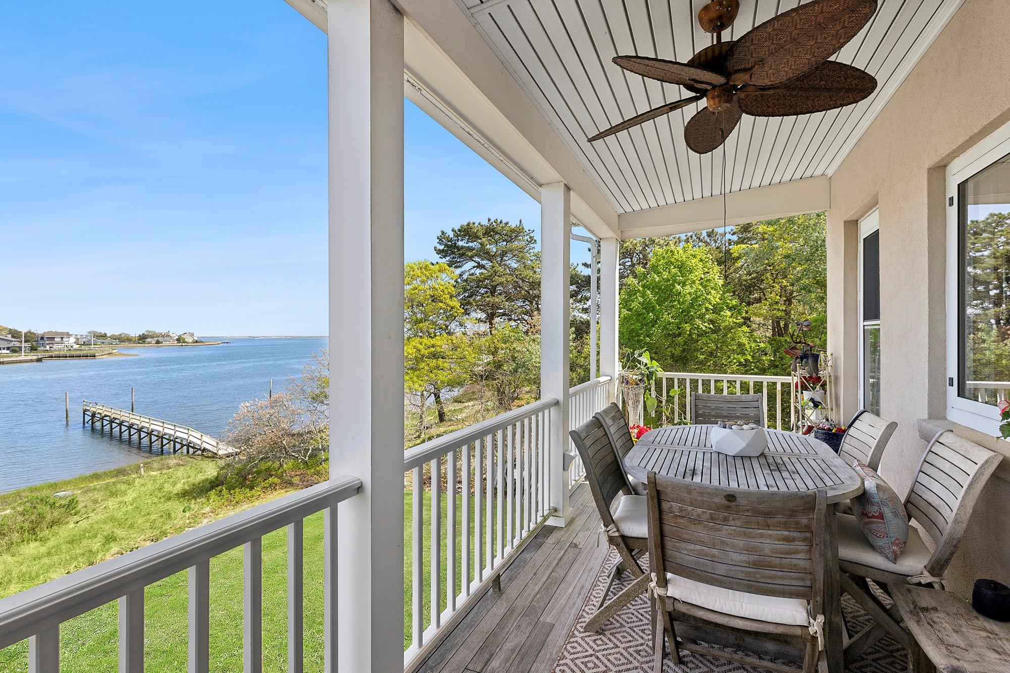 47 Rampasture Road, Unit M Hampton Bays, NY 11946 - Photo 16 of 17 a view of a chair and table in the balcony