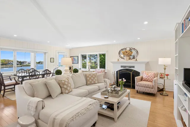 a living room with furniture a fireplace and a window