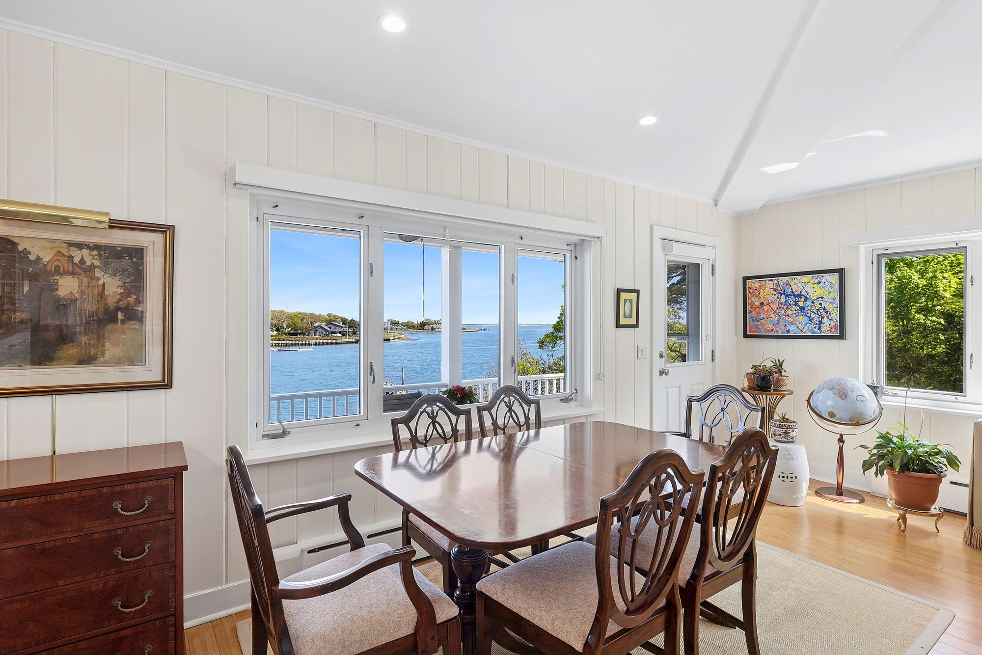 47 Rampasture Road, Unit M Hampton Bays, NY 11946 - Photo 3 of 17 a view of a dining room with furniture window and wooden floor