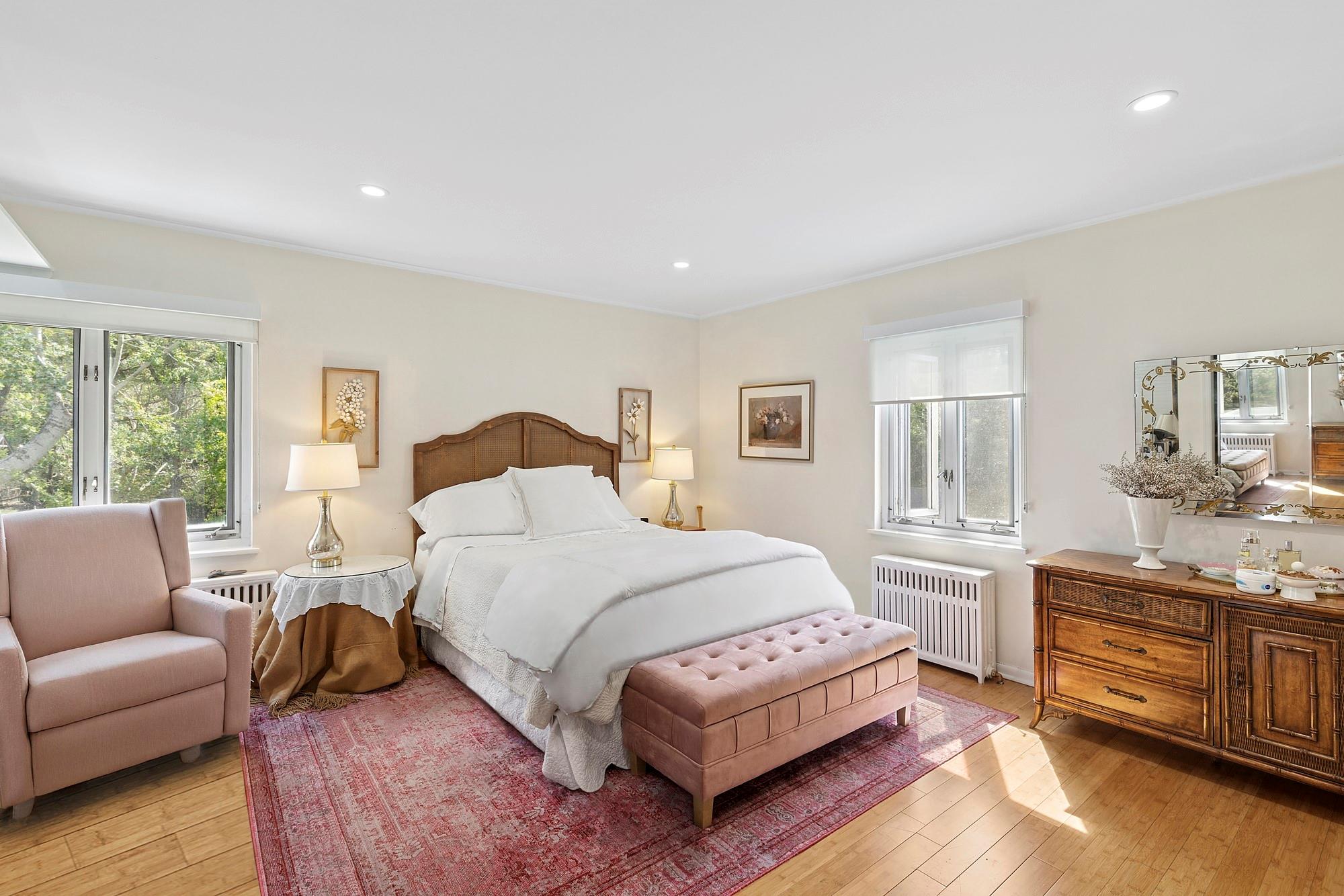 47 Rampasture Road, Unit M Hampton Bays, NY 11946 - Photo 8 of 17 a bedroom with a bed a couch and dresser