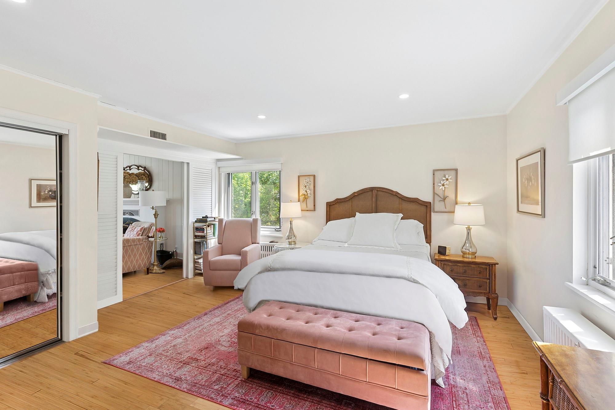 47 Rampasture Road, Unit M Hampton Bays, NY 11946 - Photo 9 of 17 a bedroom with a bed and wooden floor