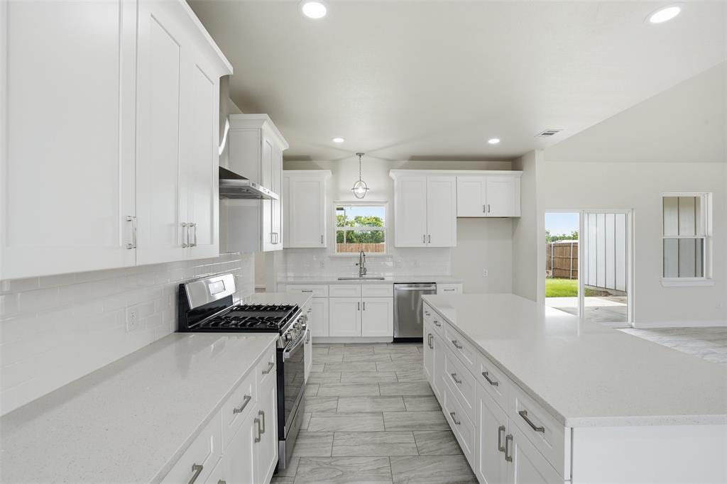 532 Highview Court Godley, TX 76044 - Photo 31 of 39 Modern kitchen featuring white shaker cabinetry, light-toned countertops, and stainless steel appliances