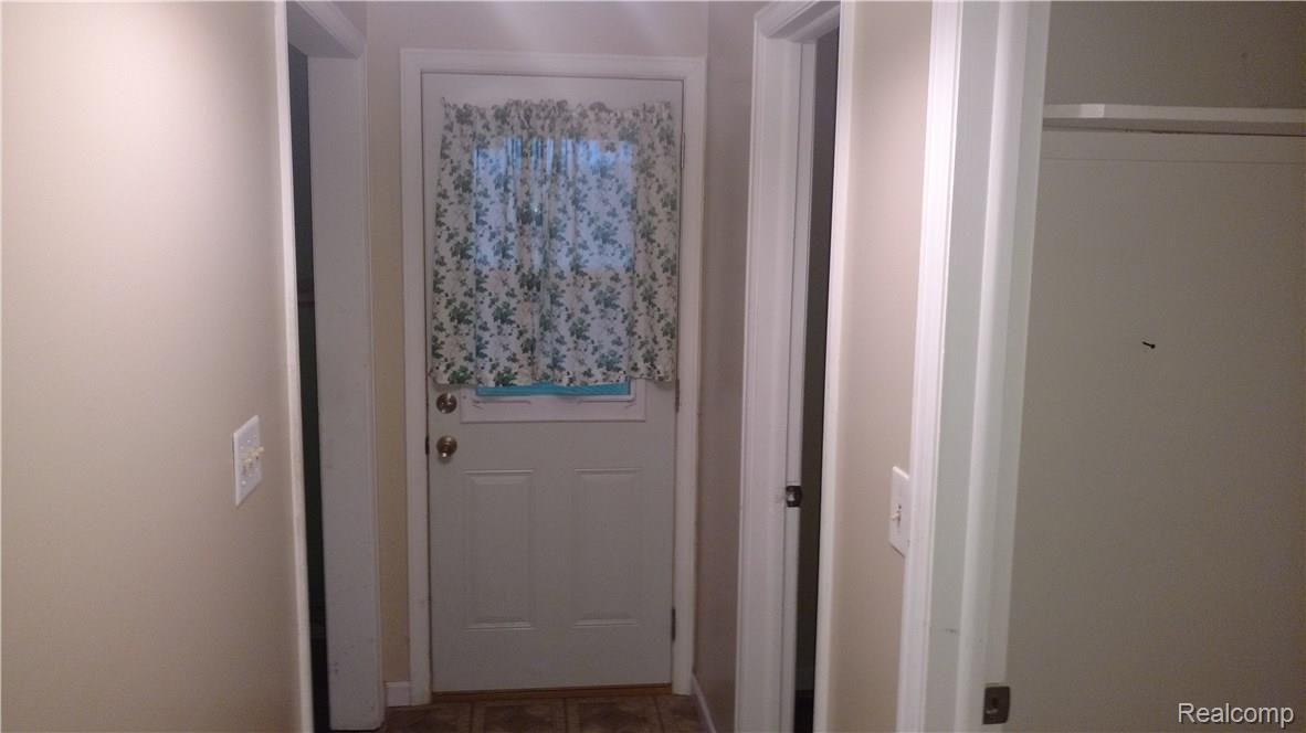 10191 Elms Road Montrose, MI 48457 - Photo 32 of 37 Hallway to Back Door, Half Bath and Laundry Room