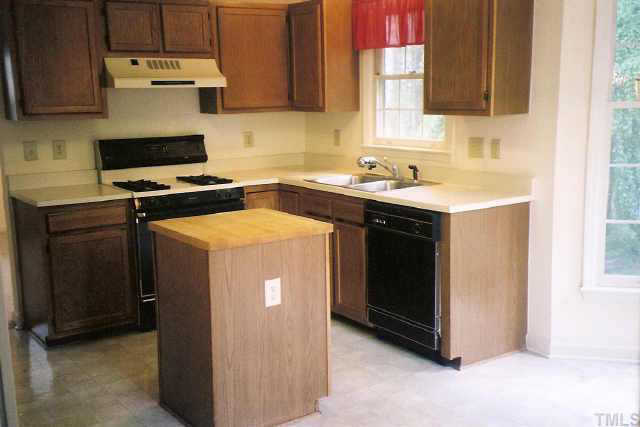5209 Blakeley Lane Raleigh, NC 27613 - Photo 5 of 10 a kitchen with a sink stove and cabinets