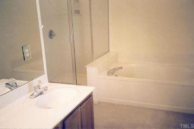 5209 Blakeley Lane Raleigh, NC 27613 - Photo 8 of 10 a bathroom with a bathtub and a sink