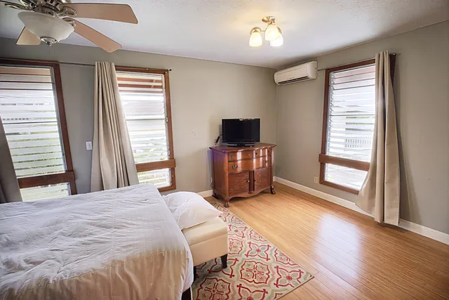 a bedroom with a bed and a flat screen tv