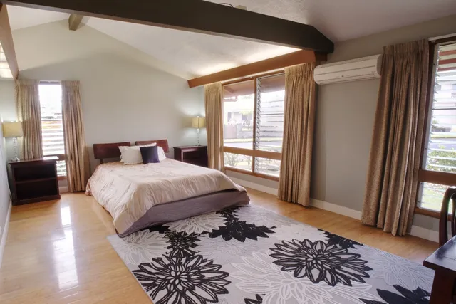 a bedroom with a large bed and a window