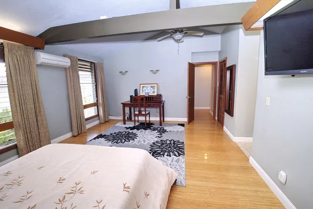 a bedroom with a bed and a flat screen tv