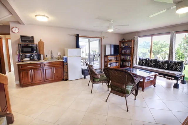 a living room with furniture a flat screen tv and a large window