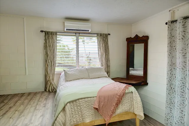 a bedroom with a bed and a mirror