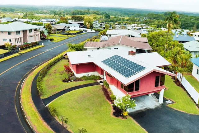 an aerial view of a swimming pool with outdoor seating