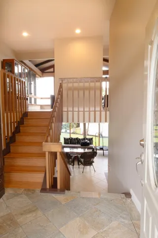 a view of entryway and hall with wooden floor