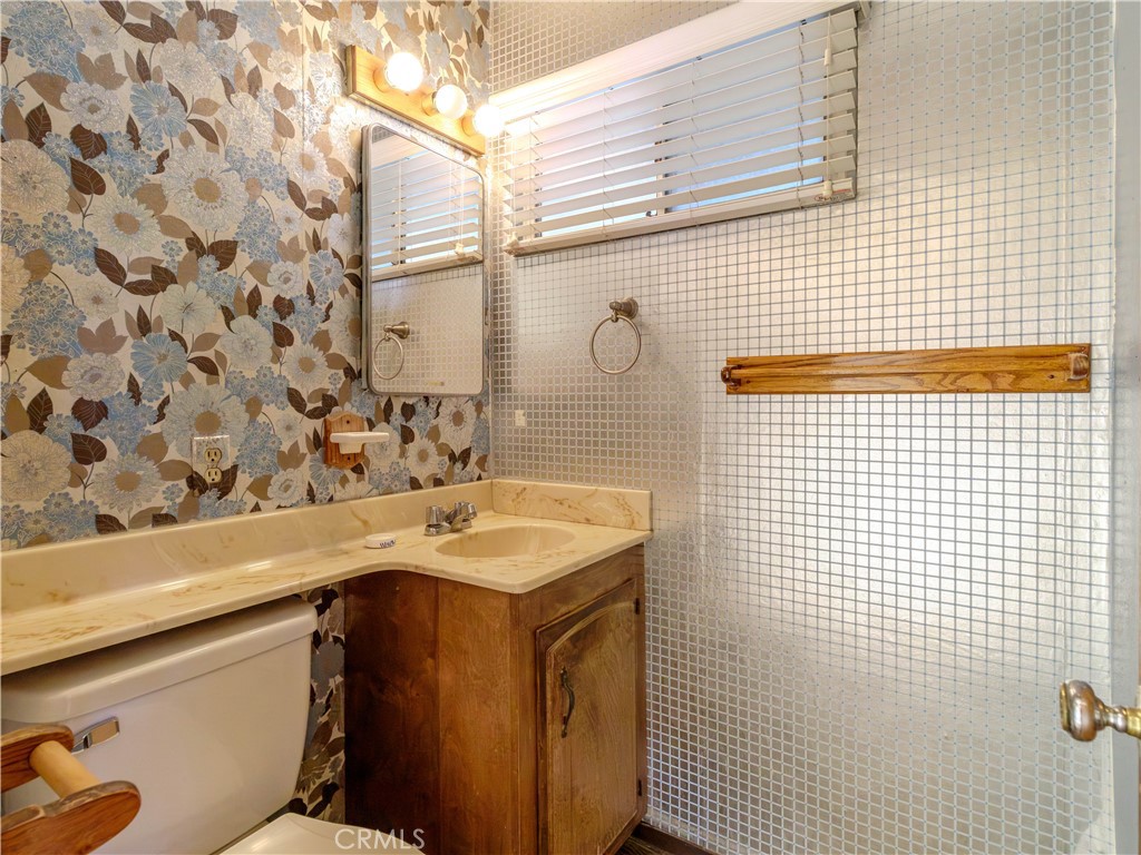 8815 San Vicente Avenue Riverside, CA 92503 - Photo 3 of 27 a bathroom with a sink vanity and a shower
