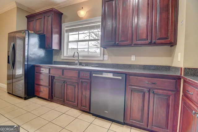 a kitchen with stainless steel appliances granite countertop a refrigerator and cabinets