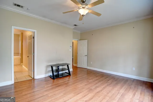 a view of a room with wooden floor and white walls