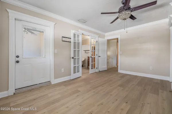a view of empty room with wooden floor