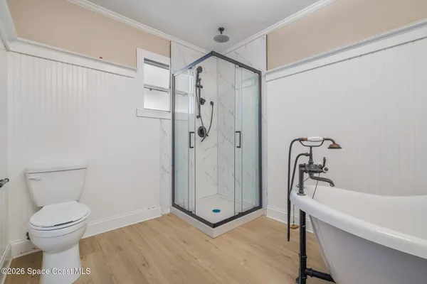 a bathroom with a shower a toilet and a shower