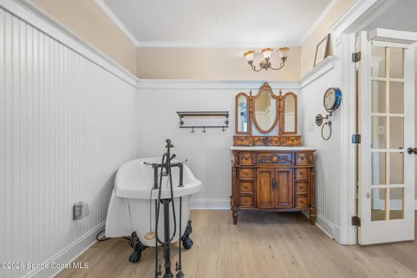 a hallway with a dining table and chairs