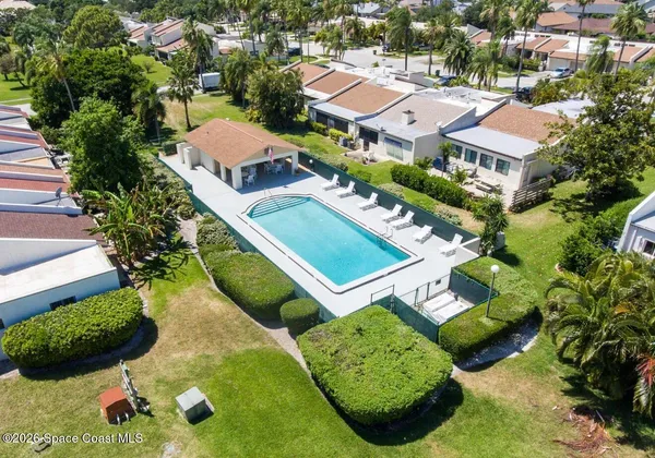 an aerial view of residential house with outdoor space and swimming pool