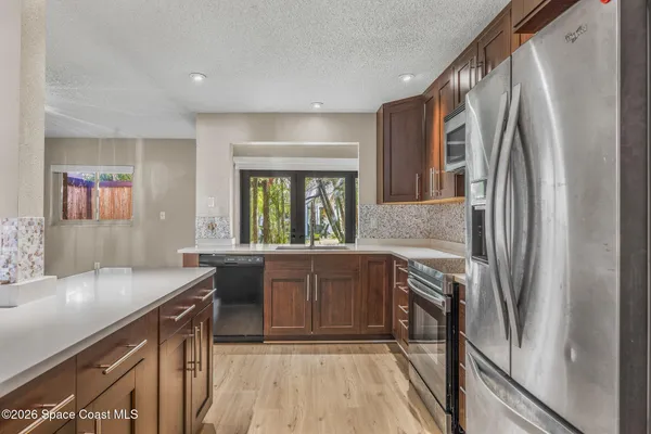 a kitchen with a sink appliances and cabinets