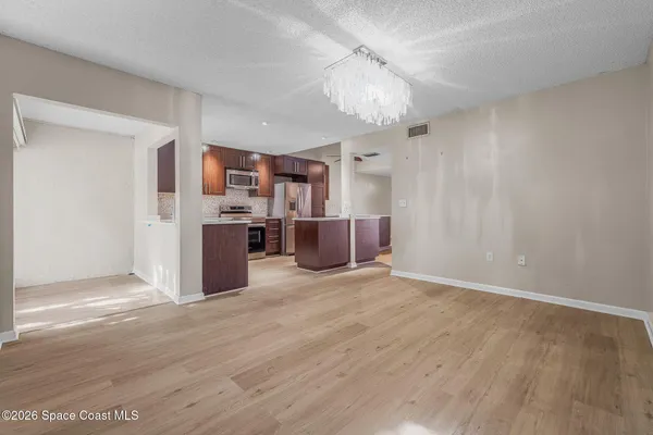 a view of a kitchen with a sink cabinets and wooden floor