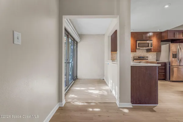 a view of a kitchen from the hallway