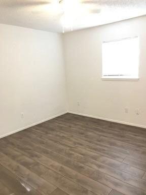 1609 38th Street Lubbock, TX 79412 - Photo 4 of 8 an empty room with wooden floor and windows