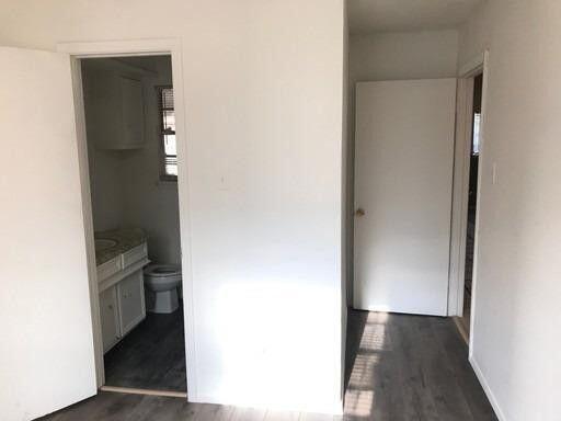 1609 38th Street Lubbock, TX 79412 - Photo 5 of 8 a view of hallway with bathroom and a toilet