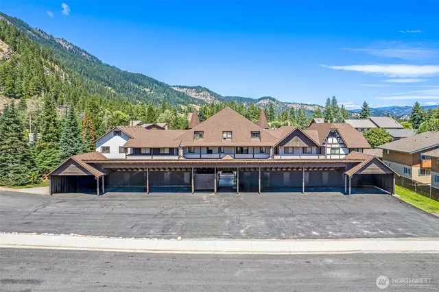 a view of a big house with a big yard and large trees