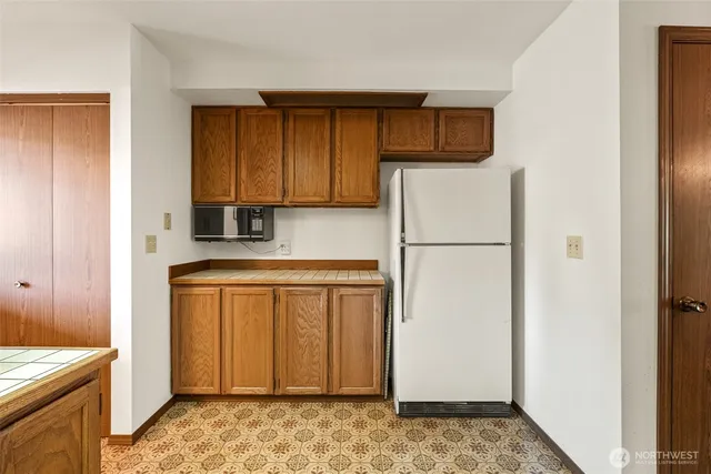 a kitchen with stainless steel appliances granite countertop a refrigerator and a stove