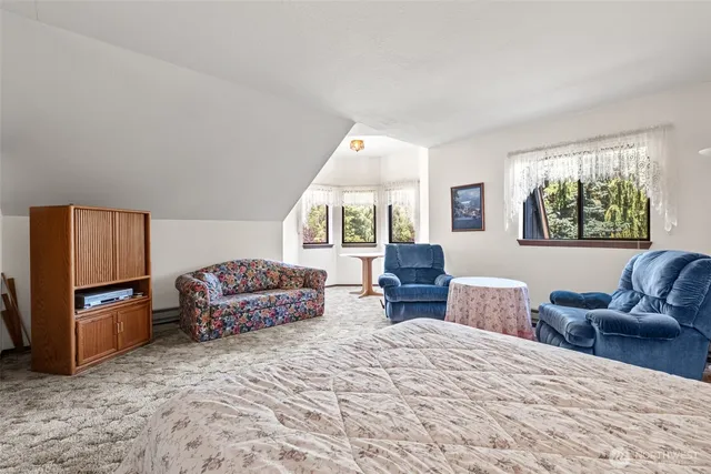 a bedroom with furniture and a window