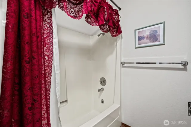 a bathroom with a bathtub and shower