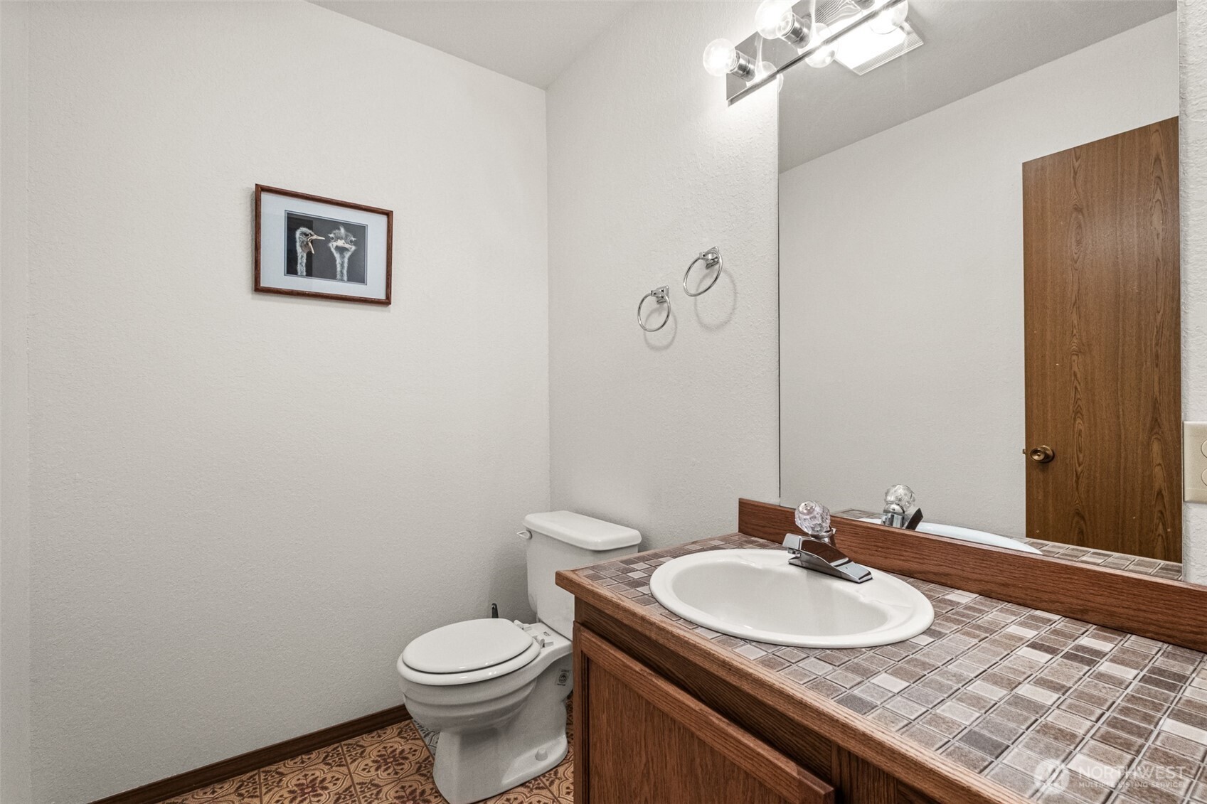 110 Icicle Road, Unit K Leavenworth, WA 98826 - Photo 25 of 26 a bathroom with a toilet sink and mirror