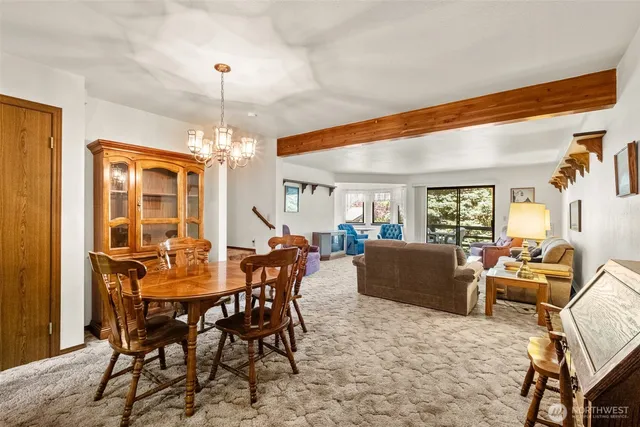 a dining room with furniture window and wooden floor