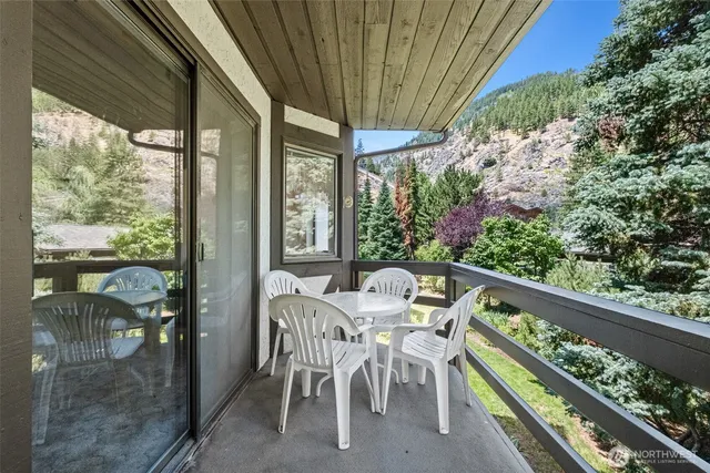 a view of a patio with a table chairs and a backyard